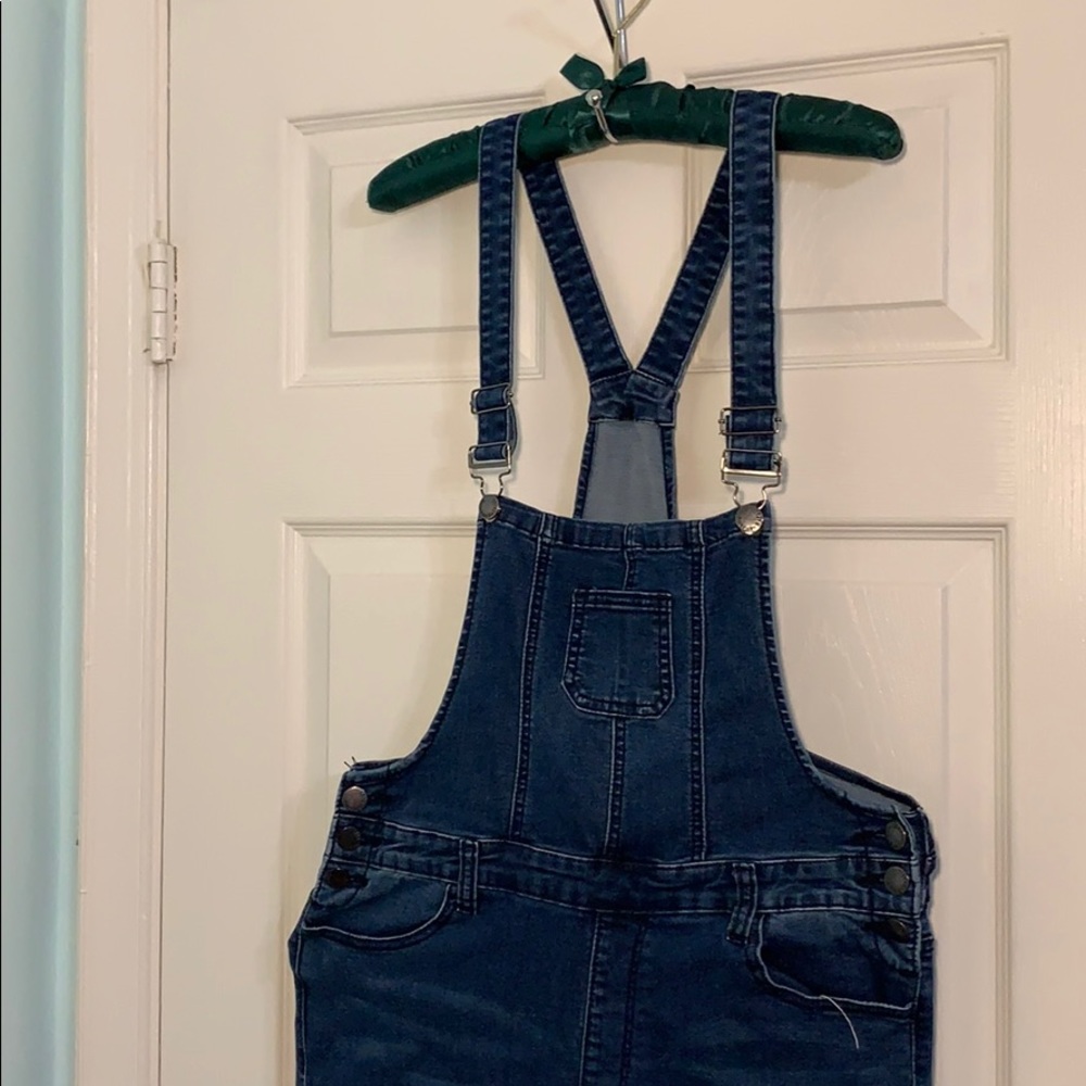 A dark blue denim ripped overalls